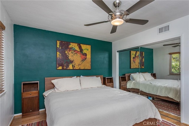 16733 Archwood St, Van Nuys, CA 91406 - bedroom featuring wood finished floors, an accent wall, ceiling fan, and a closet