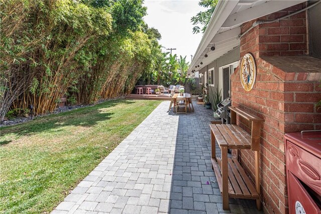 16733 Archwood St, Van Nuys, CA 91406 - view of grassy yard featuring a patio