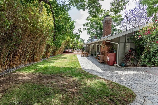16733 Archwood St, Van Nuys, CA 91406 - view of grassy yard with a patio