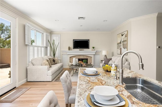14 Celonova Pl, Lake Forest, CA 92610 - living area featuring light wood-style flooring, crown molding, and a premium fireplace