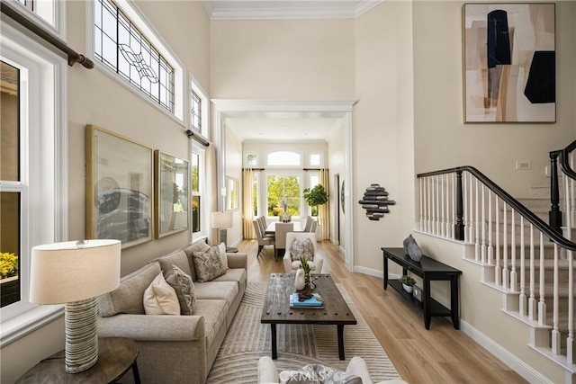 14 Celonova Pl, Lake Forest, CA 92610 - living room featuring light wood finished floors, stairway, ornamental molding, and a towering ceiling