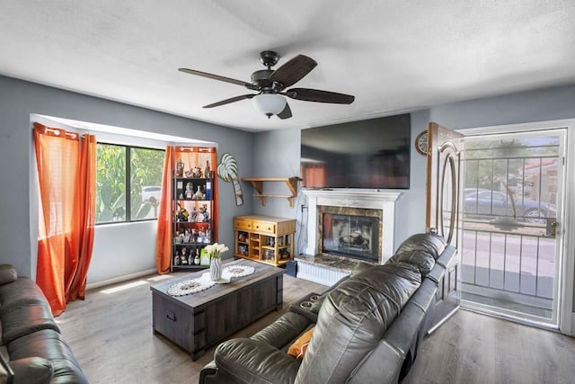 11073 Andrews St, South El Monte, CA 91733 - living room with wood finished floors, a ceiling fan, and a high end fireplace