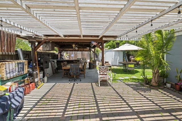 11073 Andrews St, South El Monte, CA 91733 - fenced backyard featuring outdoor dining space, a storage shed, a pergola, and a patio
