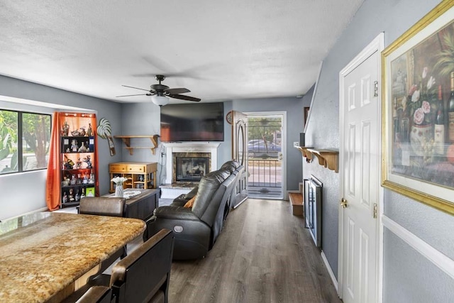 11073 Andrews St, South El Monte, CA 91733 - living room featuring a fireplace with raised hearth, dark wood-type flooring, and a ceiling fan