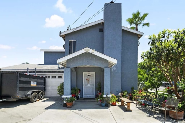 11073 Andrews St, South El Monte, CA 91733 - view of front of home with a garage, stucco siding, concrete driveway, and a chimney