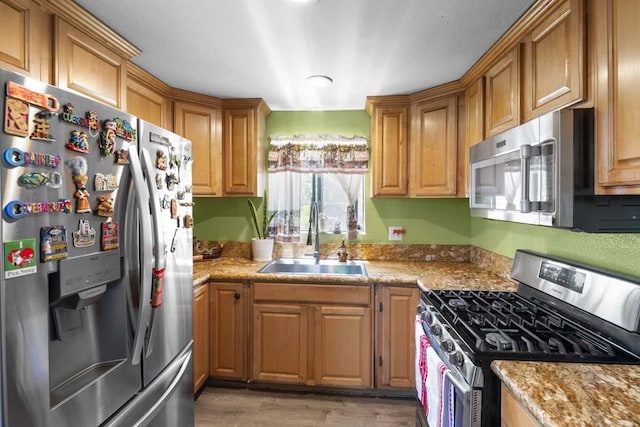 11073 Andrews St, South El Monte, CA 91733 - kitchen with appliances with stainless steel finishes, light wood-style floors, and brown cabinets