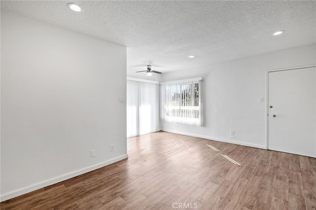 3337 S Durango Ave, Los Angeles, CA 90034 - spare room with a textured ceiling, wood finished floors, ceiling fan, baseboards, and recessed lighting
