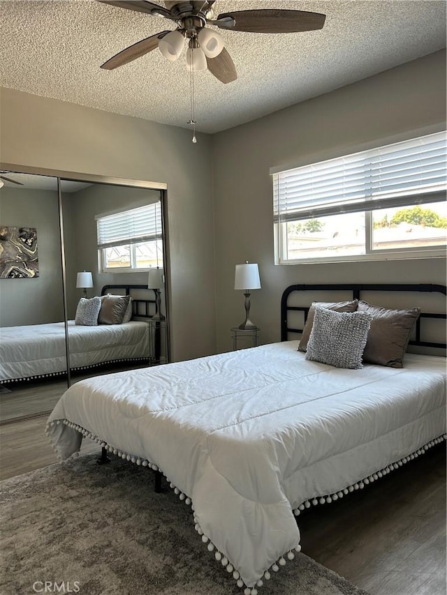 3337 S Durango Ave, Los Angeles, CA 90034 - bedroom with wood finished floors, a textured ceiling, ceiling fan, and a closet
