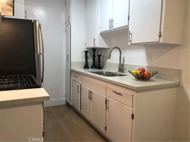 3337 S Durango Ave, Los Angeles, CA 90034 - kitchen featuring freestanding refrigerator, a sink, wood finished floors, white cabinets, and black gas stove