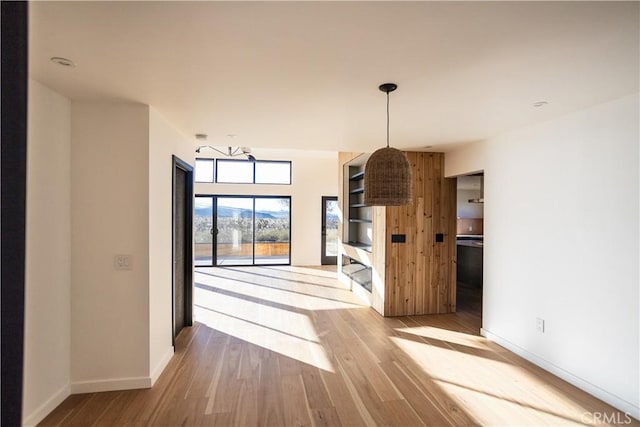 3977 Sage Ave, Yucca Valley, CA 92284 - unfurnished living room featuring wood finished floors and baseboards