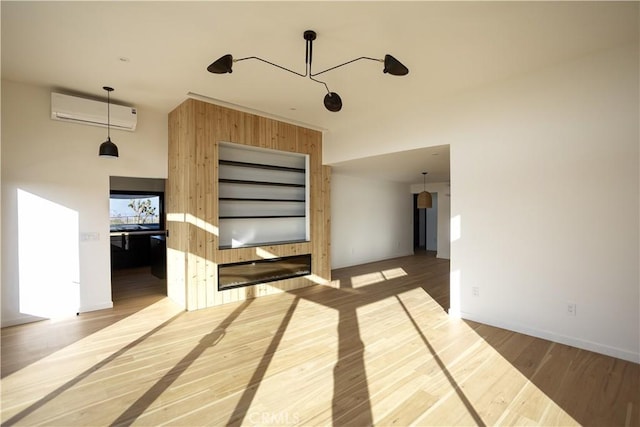 3977 Sage Ave, Yucca Valley, CA 92284 - empty room featuring a wall mounted air conditioner and wood finished floors