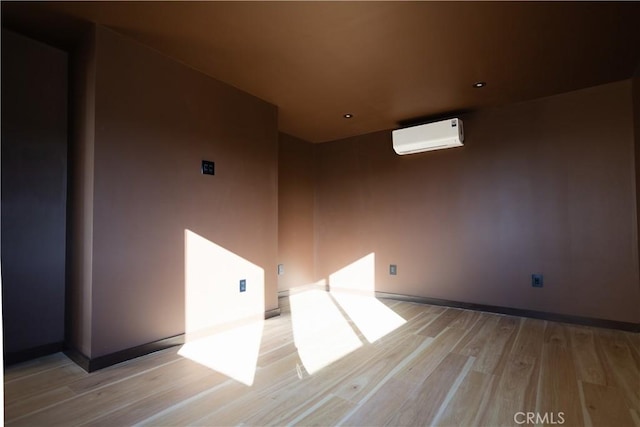 3977 Sage Ave, Yucca Valley, CA 92284 - empty room with a wall mounted air conditioner, light wood-style floors, and recessed lighting