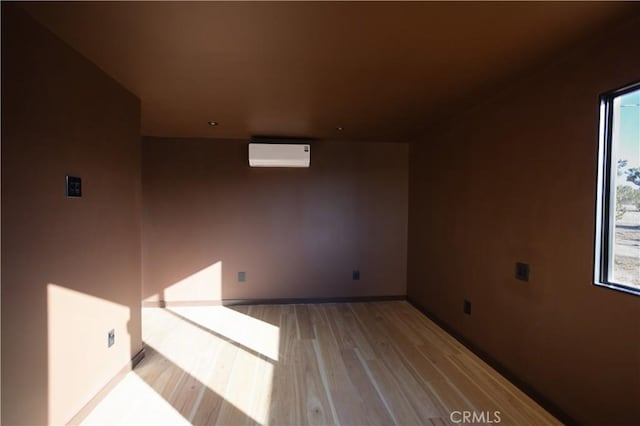 3977 Sage Ave, Yucca Valley, CA 92284 - additional living space featuring an AC wall unit, light wood-type flooring, and healthy amount of natural light