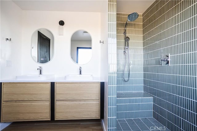 3977 Sage Ave, Yucca Valley, CA 92284 - full bathroom featuring double vanity, a tile shower, and wood finished floors