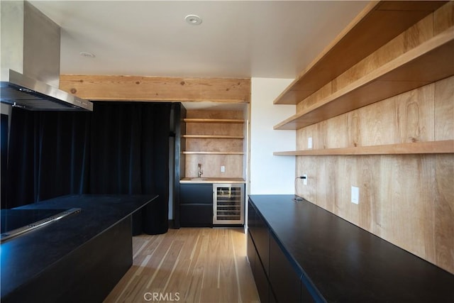 3977 Sage Ave, Yucca Valley, CA 92284 - bar area featuring wall chimney exhaust hood, wine cooler, cooktop, and light wood-style floors