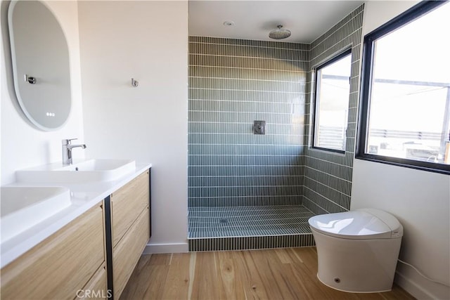 3977 Sage Ave, Yucca Valley, CA 92284 - full bathroom with double vanity, tiled shower, and wood finished floors