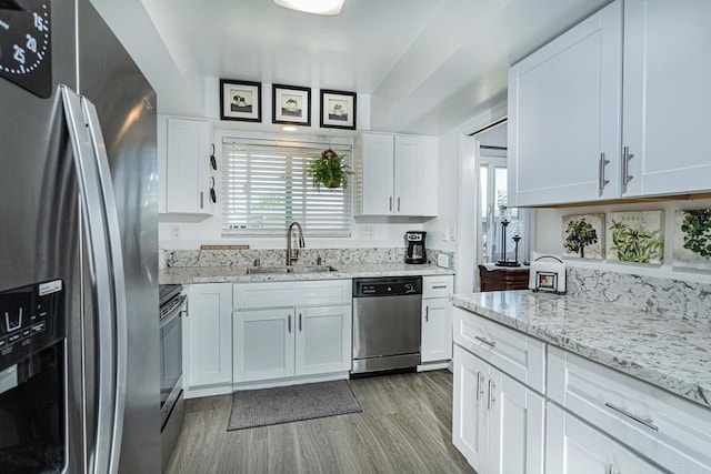 3630 S Vista Campana Unit 22, Oceanside, CA 92057 - kitchen with appliances with stainless steel finishes, a sink, plenty of natural light, and light wood finished floors