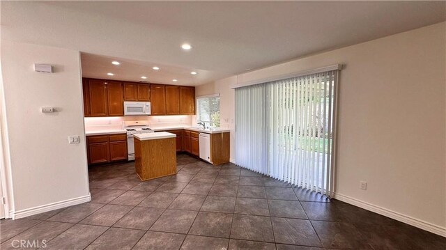 762 Saint James Dr, Corona, CA 92882 - kitchen with white appliances, a kitchen island, light countertops, recessed lighting, and baseboards