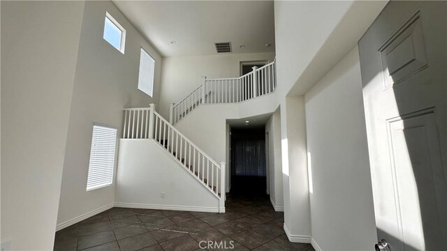 762 Saint James Dr, Corona, CA 92882 - stairway featuring tile patterned flooring, baseboards, and a towering ceiling
