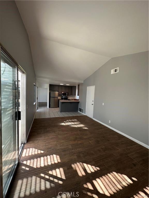 3030 Twincreek Ave, Palmdale, CA 93551 - unfurnished living room featuring vaulted ceiling, wood finished floors, and baseboards