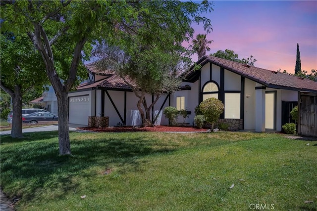 3030 Twincreek Ave, Palmdale, CA 93551 - view of front facade with stucco siding, an attached garage, a lawn, a tiled roof, and driveway