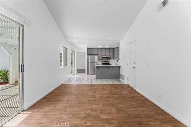 3030 Twincreek Ave, Palmdale, CA 93551 - unfurnished living room with light wood-style floors and vaulted ceiling