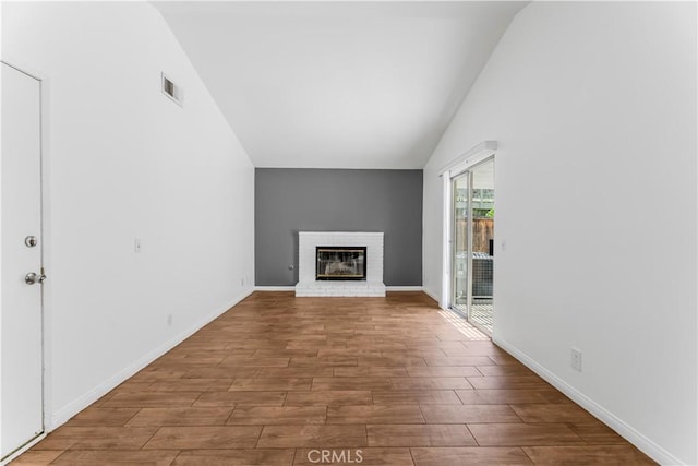 3030 Twincreek Ave, Palmdale, CA 93551 - unfurnished living room featuring vaulted ceiling, wood finished floors, and a brick fireplace