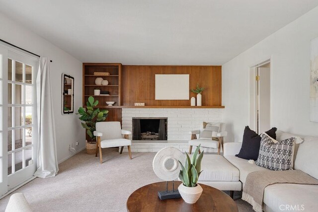 17442 Parker Dr, Tustin, CA 92780 - living room featuring carpet flooring, a brick fireplace, built in features, and wooden walls