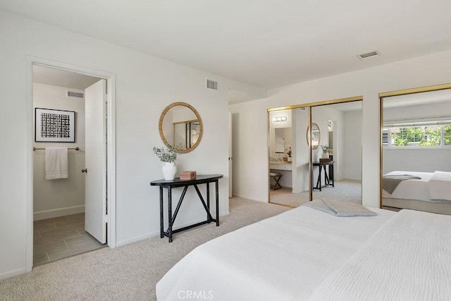 17442 Parker Dr, Tustin, CA 92780 - bedroom with carpet, two closets, baseboards, and connected bathroom