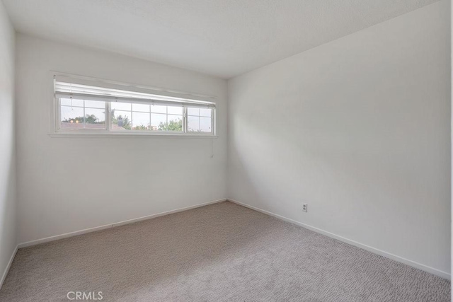 17442 Parker Dr, Tustin, CA 92780 - carpeted empty room featuring baseboards