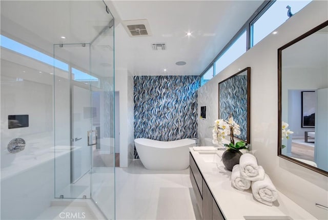 2522 The Strand, Manhattan Beach, CA 90266 - full bath with double vanity, a freestanding tub, a stall shower, and an accent wall