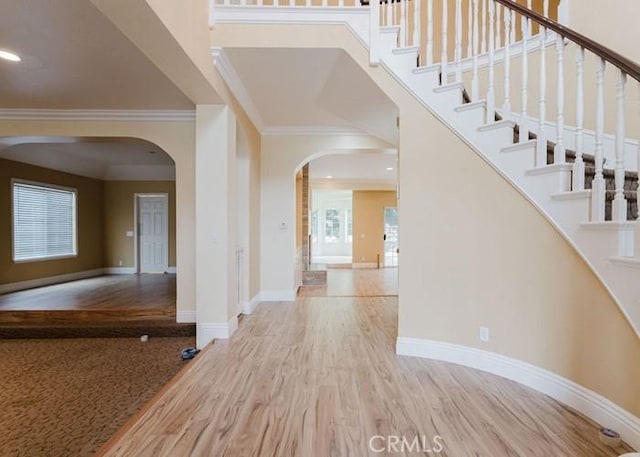 18853 Beechtree Ln, Porter Ranch, CA 91326 - foyer entrance featuring arched walkways, ornamental molding, baseboards, stairway, and recessed lighting
