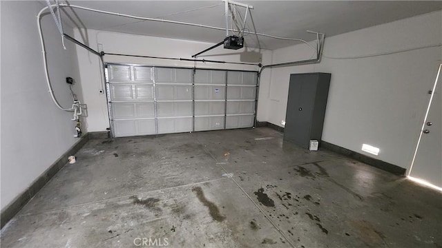 26246 Reade Pl, Stevenson Ranch, CA 91381 - garage featuring a garage door opener and baseboards