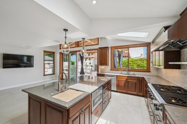2675 Clove St, San Diego, CA 92106 - kitchen with stainless steel appliances, wall chimney range hood, vaulted ceiling, plenty of natural light, and tasteful backsplash