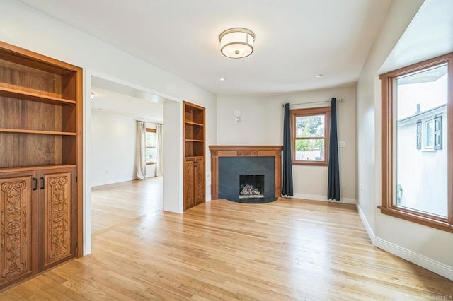 2675 Clove St, San Diego, CA 92106 - unfurnished living room with light wood finished floors and a fireplace with flush hearth