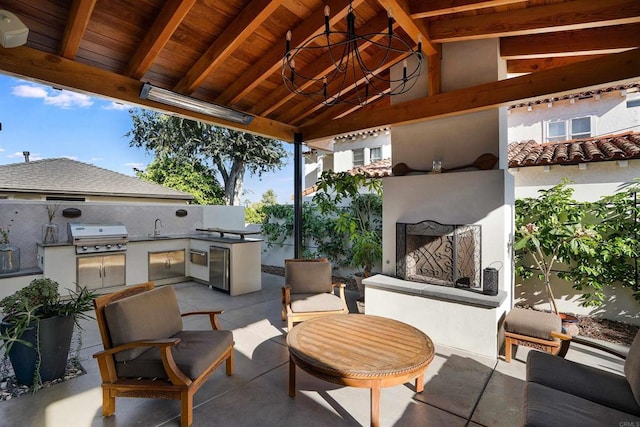 2675 Clove St, San Diego, CA 92106 - view of patio with exterior fireplace and an outdoor kitchen