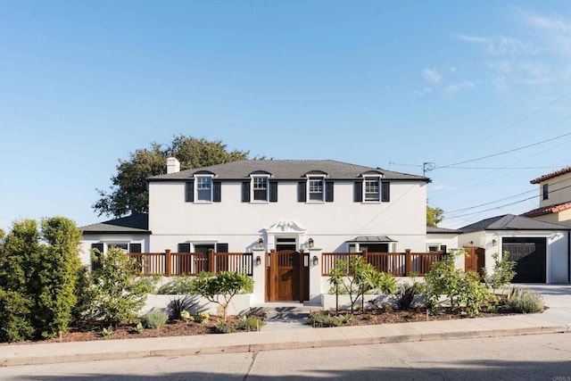 2675 Clove St, San Diego, CA 92106 - view of front facade with a fenced front yard, stucco siding, a chimney, and driveway