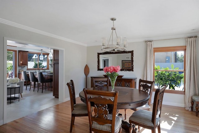 2675 Clove St, San Diego, CA 92106 - dining area featuring a chandelier, crown molding, and light wood-style flooring