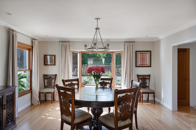 2675 Clove St, San Diego, CA 92106 - dining space with a chandelier, light wood-style floors, and crown molding