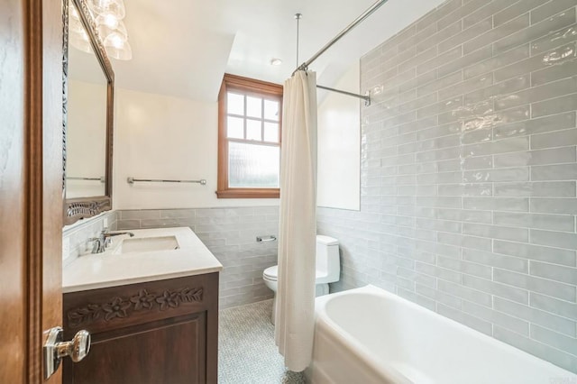 2675 Clove St, San Diego, CA 92106 - bathroom with tile walls, vanity, tile patterned floors, shower / bath combo, and a wainscoted wall