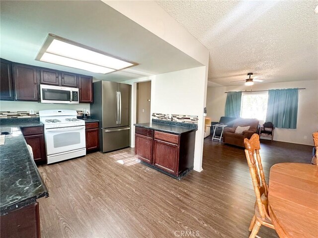 5374 Morongo Rd Unit 29, Palms, CA 92277 - kitchen featuring stainless steel appliances, wood finished floors, a textured ceiling, open floor plan, and ceiling fan