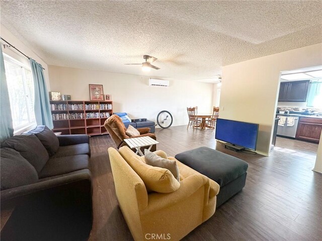 5374 Morongo Rd Unit 29, Palms, CA 92277 - living area featuring a wall mounted AC, wood finished floors, a textured ceiling, and a ceiling fan