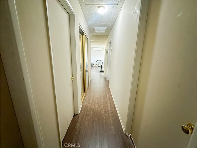 5374 Morongo Rd Unit 29, Palms, CA 92277 - corridor featuring a textured ceiling, wood finished floors, and baseboards