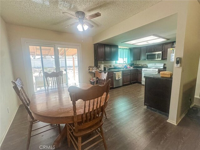 5374 Morongo Rd Unit 29, Palms, CA 92277 - dining room featuring dark wood finished floors, a ceiling fan, a textured ceiling, and baseboards