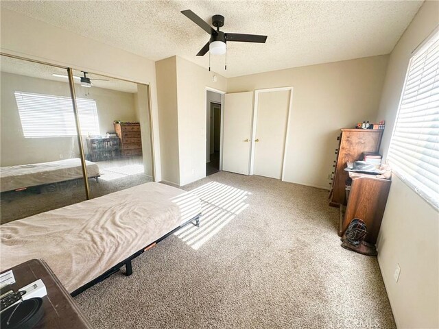 5374 Morongo Rd Unit 29, Palms, CA 92277 - carpeted bedroom featuring a textured ceiling, a closet, and ceiling fan