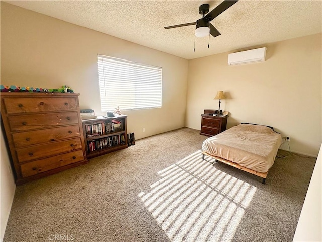 5374 Morongo Rd Unit 29, Palms, CA 92277 - carpeted bedroom with a wall mounted air conditioner, a textured ceiling, and ceiling fan