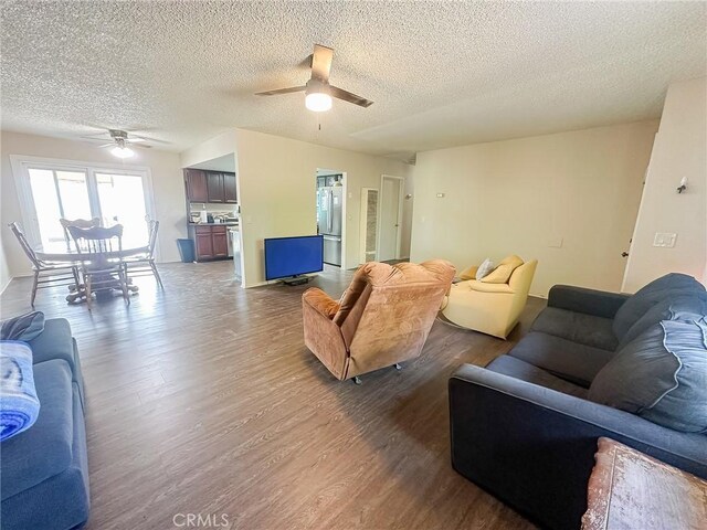 5374 Morongo Rd Unit 29, Palms, CA 92277 - living room featuring ceiling fan, dark wood-type flooring, and a textured ceiling