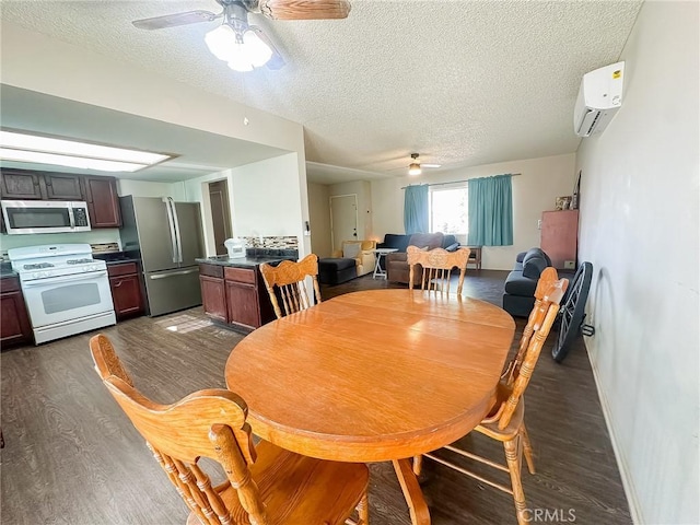 5374 Morongo Rd Unit 29, Palms, CA 92277 - dining room featuring ceiling fan, a wall unit AC, dark wood-style floors, a textured ceiling, and baseboards