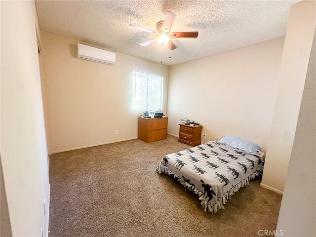 5374 Morongo Rd Unit 29, Palms, CA 92277 - carpeted bedroom with an AC wall unit, a textured ceiling, and a ceiling fan