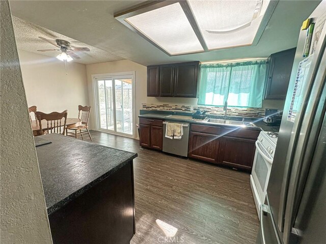 5374 Morongo Rd Unit 29, Palms, CA 92277 - kitchen featuring appliances with stainless steel finishes, dark countertops, healthy amount of natural light, and a textured ceiling